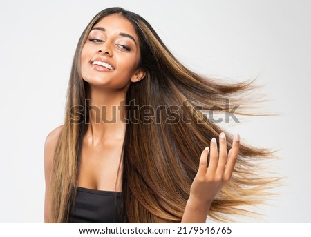 Brown Hair Beauty Woman. Brunette Model with Shiny Straight Long Hairstyle. Hair Care Spa and Keratin Straightening over White. Cheerful Smiling Girl touching flying Healthy Smooth Hair