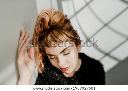 Brown hair woman in a black fluffy sweater