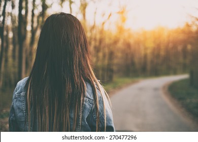 Brown Hair Woman On The Road Rear View