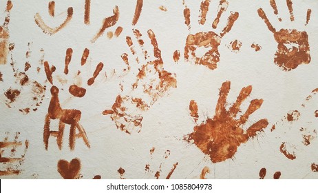 brown handprints on the wall. imprint fingerprints  background.  