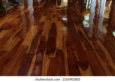 Brown hardwood floors with a shiny lacquered finish.