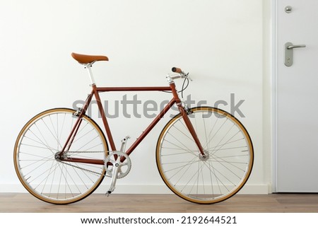 Brown hipster urban bicycle at apartment home. 