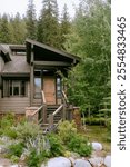 brown home in the mountains nestled in aspen and evergreen trees