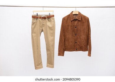 Brown Jacket ,shirt With Khaki Pants Isolated On Hanger Background