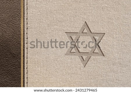 Brown Jewish religious design with leather and fabric texture with the star of David engraved. Top view.