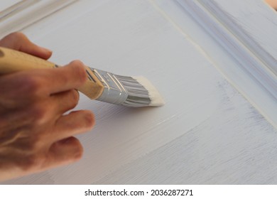 A Brown Kitchen Cabinet Is Painted With White Chalk Paint 