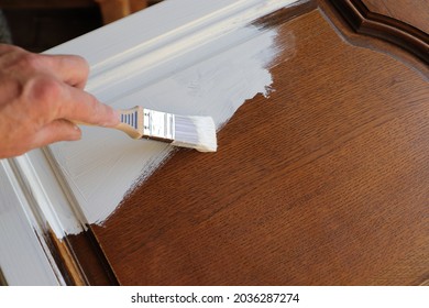 A Brown Kitchen Cabinet Is Painted With White Chalk Paint 