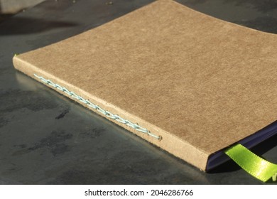 Brown Kraft Paper Notebook With Handmade Green Stitching.