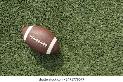 A brown leather American football on a green football field - Powered by Shutterstock