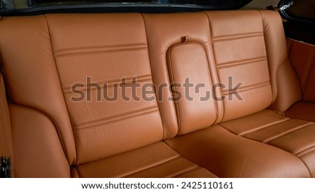 Brown leather back seat inside a car
