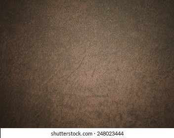 Brown leather book cover used as background.
