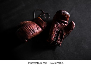 Brown Leather Boxing Gloves On A Training Mat Black Background Top View.mockup