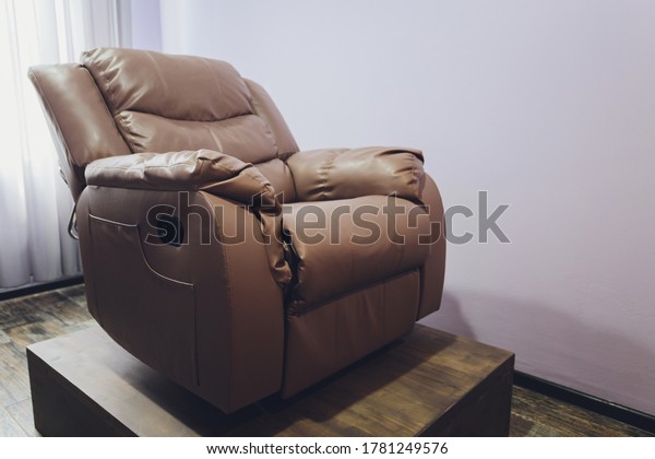 Brown leather comfortable reclining\
massage chair With Tapping and Kneading therapeutic massages\
isolated on white background. This has clipping\
path.