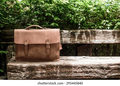 Brown Leather Laptop Bag Corporate  On Old Woden Chair