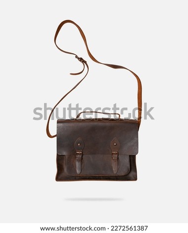 Brown leather men's bag, briefcase isolated on gray background. Cut out object, document suitcase, business, shoulder bag, vintage backpack. Fashion, style, accessory mockup