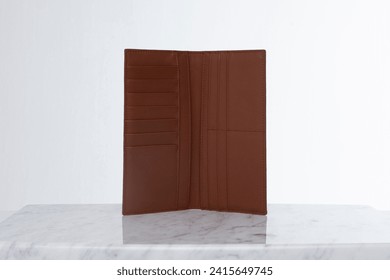 Brown leather men's wallet for credit cards and money on marble floor and white backdrop in studio - Powered by Shutterstock