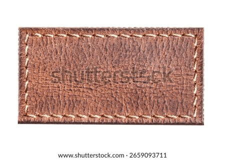 Brown leather patch isolated. Texture detail with stitched border. High resolution rectangle shape. Blank label for design. Classic material sample on white background. Textile element for mockups.