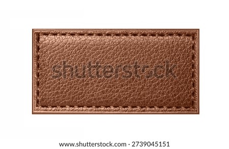 Brown leather patch label isolated on white background. Textured natural leather surface. Stitched rectangle tag detail. Blank branding badge element. Fashion garment accessory. Copy space template.