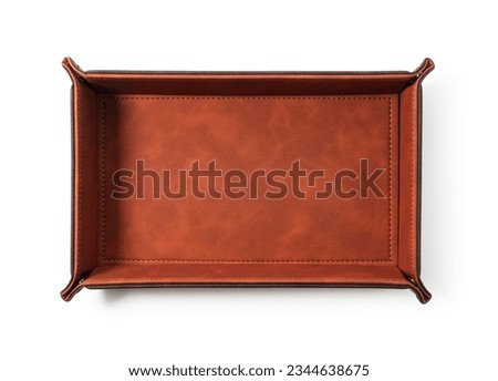 Brown leather tray placed on white background. View from directly above.