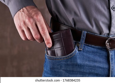 Brown Leather Wallet At Front Jean Pocket. Still Life Photo. Economy Concept.