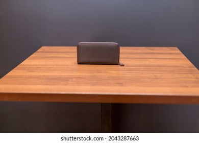 Brown Leather Wallet On The Wooden Table. Unisex Wallet.