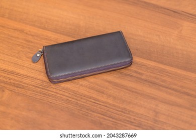 Brown Leather Wallet On The Wooden Table. Unisex Wallet.