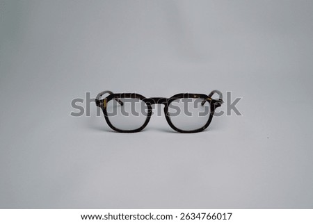 Brown leopard pattern square sunglasses, facing forward isolated on white background. Minimalist view of the glasses at a 45 degree angle with space for text.