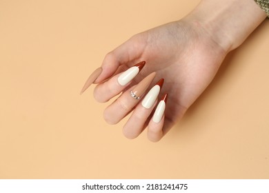 Brown manicure and coffee beans. - Shutterstock ID 2181241475