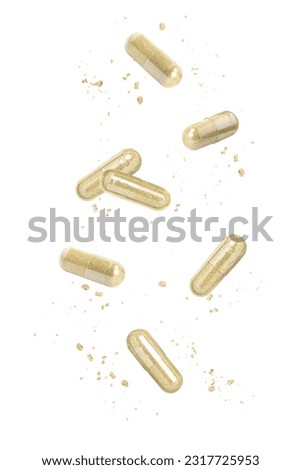brown medicine herbal powder capsule flying in the air isolated on white background. 