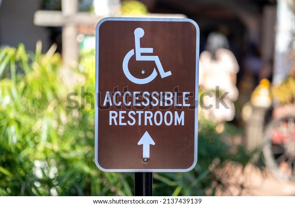 Brown Metal Accessible\
Restroom sign 