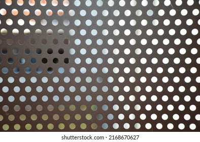 Brown Metal Plate Pierced With Many Round Holes