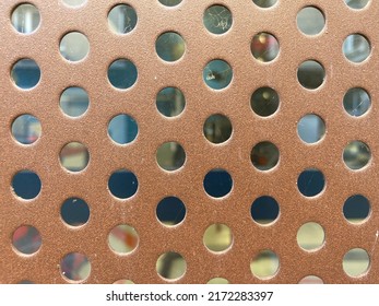 Brown Metal Plate Pierced With Round Holes