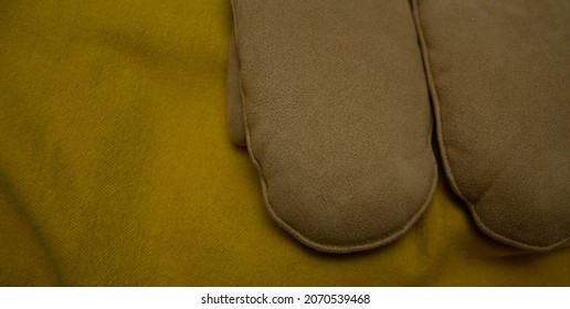 Brown Mittens On A Yellow Scarf, Isolated