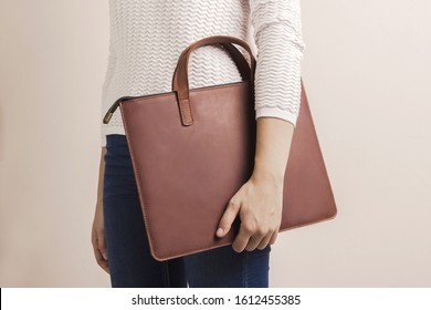 Brown Modern Unisex Leather Bag For Laptop. Person Holding Case. Minimalist Inclusion Clothing Concept 