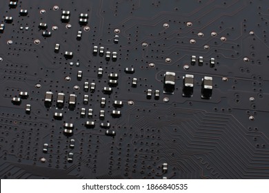 Brown Motherboard With A Lot Of Smd Components. Huge Number Of Different Size Ceramic Surface Mount Capacitors, Pcb Traces And Vias.