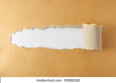 Brown Package Paper Torn To Reveal White Panel Ideal For Copy Space