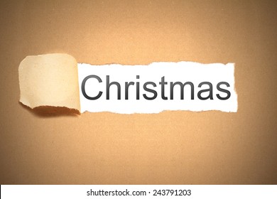 brown packaging paper torn to reveal christmas - Shutterstock ID 243791203