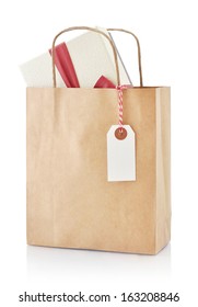 Brown Paper Bag With Gift And Paper Tag Isolated On A White Background