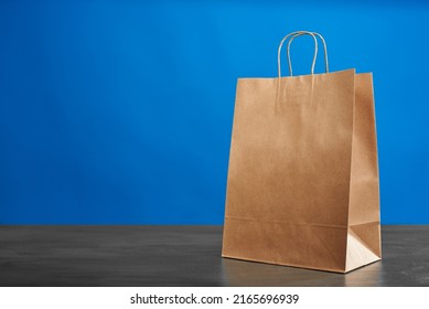 A Brown Paper Bag With Handles On A Blue Background. ECO Bag. Craft Paper Bag. Recycled Paper. Environmentally Friendly Bags.