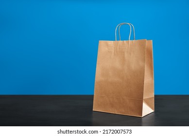 A Brown Paper Bag With Handles On A Blue Background. ECO Bag. Craft Paper Bag. Recycled Paper. Environmentally Friendly Bags.