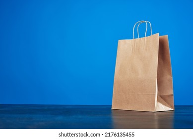 A Brown Paper Bag With Handles On A Blue Background. ECO Bag. Craft Paper Bag. Recycled Paper. Environmentally Friendly Bags.