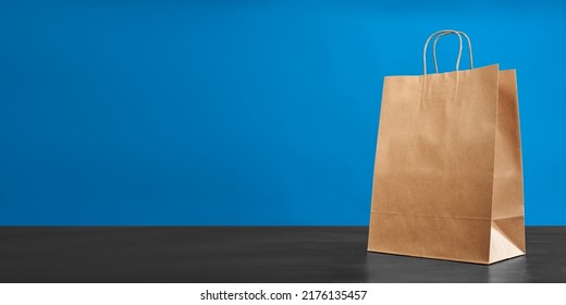 A Brown Paper Bag With Handles On A Blue Background. ECO Bag. Craft Paper Bag. Recycled Paper. Environmentally Friendly Bags.