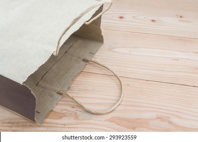 Brown Paper Bag Lying On A Wood Table