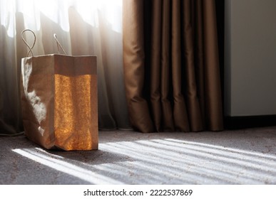 Brown Paper Bag In Room With Sunlight Shining Through