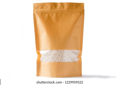 Brown Paper Doypack Stand Up Bio Pouch With Window  Zipper On White Background Filled With Rice