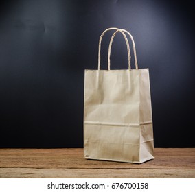 Brown Paper Shopping Bag On Wooden Board