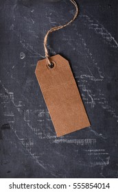 brown paper tag with string on the blackboard