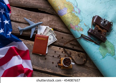 Brown passport and US flag. Photo camera on a map. Spend your vacation abroad. Visa to USA is opened.
