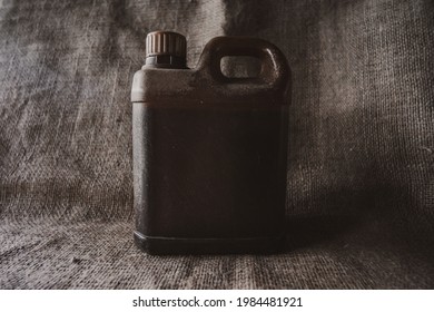 Brown Plastic Jerry Can On Brown Burlap