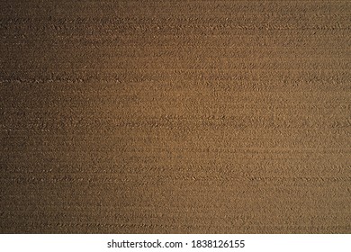 Brown plowed field. Brown background on the field aerial view. Earth top view.